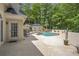 Backyard oasis featuring a pool, spa, seating and umbrella, perfect for relaxing at 2885 Coles Way, Atlanta, GA 30350