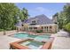 Backyard oasis with a swimming pool, integrated spa, and outdoor seating area next to the home at 2885 Coles Way, Atlanta, GA 30350