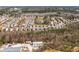 A wide aerial view of a large neighborhood with rows of homes nestled among trees, near commercial areas at 311 Ivy Chase Loop, Dallas, GA 30157
