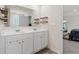 Modern bathroom with double vanity, framed mirror, stylish shelving and view to the connected bedroom at 311 Ivy Chase Loop, Dallas, GA 30157