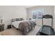 Cozy bedroom features neutral decor, a double bed, an exercise machine, and a view of the neighborhood at 311 Ivy Chase Loop, Dallas, GA 30157
