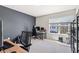 Comfortable and functional bedroom features a home office setup near large window overlooking the outdoors at 311 Ivy Chase Loop, Dallas, GA 30157