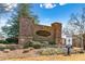 Community entrance with beautiful brick signage, manicured landscaping, and clear directions to model home at 311 Ivy Chase Loop, Dallas, GA 30157