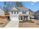 Charming two-story home with a well-manicured lawn and a welcoming front porch at 311 Ivy Chase Loop, Dallas, GA 30157