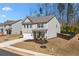 Charming home exterior with a well-manicured lawn, a covered porch, and a two-car garage at 311 Ivy Chase Loop, Dallas, GA 30157