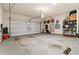 Spacious two car garage with ample storage space, shelving, and an automatic garage door at 311 Ivy Chase Loop, Dallas, GA 30157