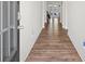 View of the hallway with wood floors, leading to a bright living area, creating a welcoming ambiance at 311 Ivy Chase Loop, Dallas, GA 30157