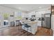 Bright kitchen features stainless steel appliances, granite countertops, and a central island at 311 Ivy Chase Loop, Dallas, GA 30157