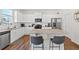 Well-lit kitchen features granite countertops, stainless steel appliances and white cabinetry at 311 Ivy Chase Loop, Dallas, GA 30157