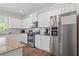 Modern kitchen features stainless steel appliances, granite countertops, and white cabinets at 311 Ivy Chase Loop, Dallas, GA 30157