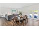 Open-concept living space features a dining table, access to the patio, and a fireplace with decorative mantle at 311 Ivy Chase Loop, Dallas, GA 30157