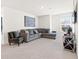 Cozy living room with comfortable sectional couch, accent chair, and modern artwork on the wall at 311 Ivy Chase Loop, Dallas, GA 30157