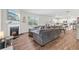 Open concept living room with wood floors, fireplace, access to a dining area, and a fully equipped kitchen at 311 Ivy Chase Loop, Dallas, GA 30157