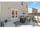 Back patio with outdoor furniture set including chairs, small sofa, and a fire pit table at 311 Ivy Chase Loop, Dallas, GA 30157