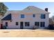 Rear exterior of the home highlighting the patio, expansive lawn, and architecture, perfect for outdoor gatherings and enjoyment at 5289 Browning Sw Way, Lilburn, GA 30047