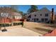 Expansive backyard with a basketball court, patio furniture, and lush greenery, ideal for recreation and relaxation at 5289 Browning Sw Way, Lilburn, GA 30047