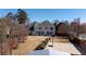 Wide backyard view, with a basketball court, lawn, mature trees, and home's back exterior at 5289 Browning Sw Way, Lilburn, GA 30047