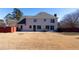 Spacious backyard with patio and furniture perfect for gatherings, framed by a privacy fence, and expansive lawn at 5289 Browning Sw Way, Lilburn, GA 30047