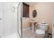 Bathroom featuring glass enclosed shower and pedestal sink at 5289 Browning Sw Way, Lilburn, GA 30047