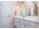 Bathroom featuring white cabinetry, double sinks, and a large mirror at 5289 Browning Sw Way, Lilburn, GA 30047
