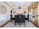 Formal dining room with elegant decor, wainscoting, tray ceiling, and chandelier at 5289 Browning Sw Way, Lilburn, GA 30047