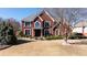 Two-story home with manicured lawn and landscape, complete with covered entry and ample natural light at 5289 Browning Sw Way, Lilburn, GA 30047