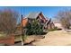 View of property with side of home, driveway, lawn and mature landscaping at 5289 Browning Sw Way, Lilburn, GA 30047