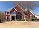 Charming two-story red brick home with well-manicured lawn and landscaping, creating inviting curb appeal at 5289 Browning Sw Way, Lilburn, GA 30047
