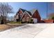 Side exterior showcases driveway and garage, framed by the yard and landscaping, under a clear sky at 5289 Browning Sw Way, Lilburn, GA 30047