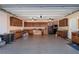 Spacious garage featuring ample cabinetry, work area, and ceiling fans for comfortable project execution and storage at 5289 Browning Sw Way, Lilburn, GA 30047