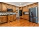 Well-equipped kitchen featuring wooden cabinets, granite countertops, and stainless steel appliances at 5289 Browning Sw Way, Lilburn, GA 30047