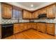 Well-equipped kitchen featuring wooden cabinets, granite countertops, and modern appliances at 5289 Browning Sw Way, Lilburn, GA 30047