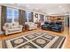 Open-concept living area with hardwood floors, comfortable seating, and natural light at 5289 Browning Sw Way, Lilburn, GA 30047