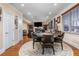 Open-concept living area with a fireplace, TV, and a dining area adjacent to the kitchen at 5289 Browning Sw Way, Lilburn, GA 30047