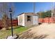 Backyard shot of storage shed set back from yard perimeter at 5289 Browning Sw Way, Lilburn, GA 30047
