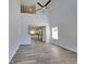 Open concept view of the living room with high ceilings, a ceiling fan, and a view of the adjacent kitchen at 55 Heyman Dr, Covington, GA 30016