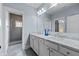 Bathroom featuring a double sink vanity with marble countertop and tiled shower at 5930 Brundage Ln, Norcross, GA 30071