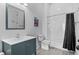 Bathroom with a shower-tub combo and blue vanity at 5930 Brundage Ln, Norcross, GA 30071