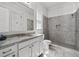 Bathroom featuring a granite vanity, walk-in shower with gray tiling, and modern fixtures at 5930 Brundage Ln, Norcross, GA 30071