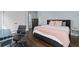 Bright bedroom features dark wood floors, a large bed, and a comfortable workspace at 5930 Brundage Ln, Norcross, GA 30071