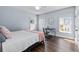 Comfortable bedroom with natural light, hardwood floors, and simple decor at 5930 Brundage Ln, Norcross, GA 30071