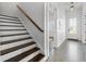 Hallway features wooden staircase and light tile floors leading to the front door at 5930 Brundage Ln, Norcross, GA 30071