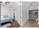 Hallway leads to a bedroom featuring hardwood floors, ceiling fan and accent rug at 5930 Brundage Ln, Norcross, GA 30071