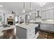 Open concept kitchen with grey cabinets, stainless steel appliances, and hardwood floors at 5930 Brundage Ln, Norcross, GA 30071