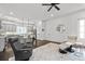 Open concept living area with view to the kitchen, with gray cabinets and hardwood floors at 5930 Brundage Ln, Norcross, GA 30071