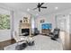 Bright living room with hardwood floors, a stone fireplace, and three leather chairs at 5930 Brundage Ln, Norcross, GA 30071