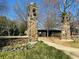 Stone pillars and flower beds mark the entrance to the park and community center at 5930 Brundage Ln, Norcross, GA 30071