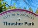 City of Norcross Thrasher Park sign with landscape backdrop at 5930 Brundage Ln, Norcross, GA 30071