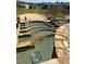 Multi-tiered stone water feature with clear water and accessible seating at 5930 Brundage Ln, Norcross, GA 30071