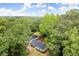 Aerial view of a home surrounded by mature trees, offering privacy and natural beauty at 6405 Cherry Tree Ln, Atlanta, GA 30328